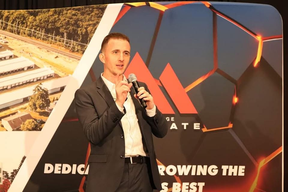 Jeremy Wenger speaking on stage about land feasibility and development strategy